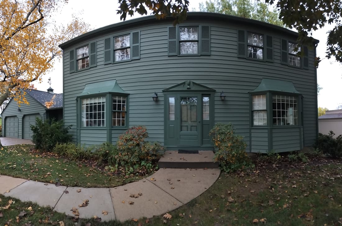 The west elevation and entry, finished — the same view as the mid-job photo.