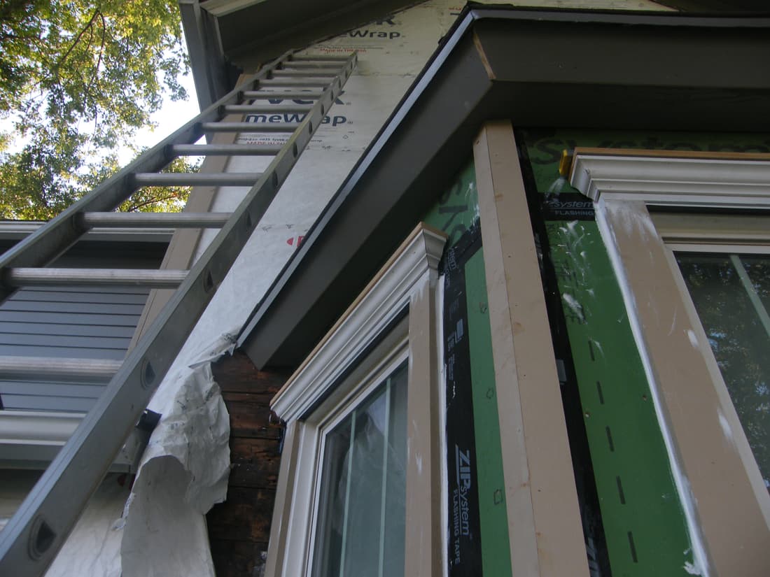 New fascia on the bay, with a cornice over the window below.