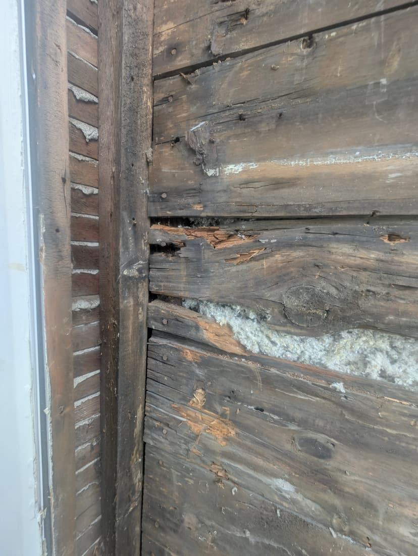 Behind the bay siding, the sheathing boards rotted and opened up at the joints.