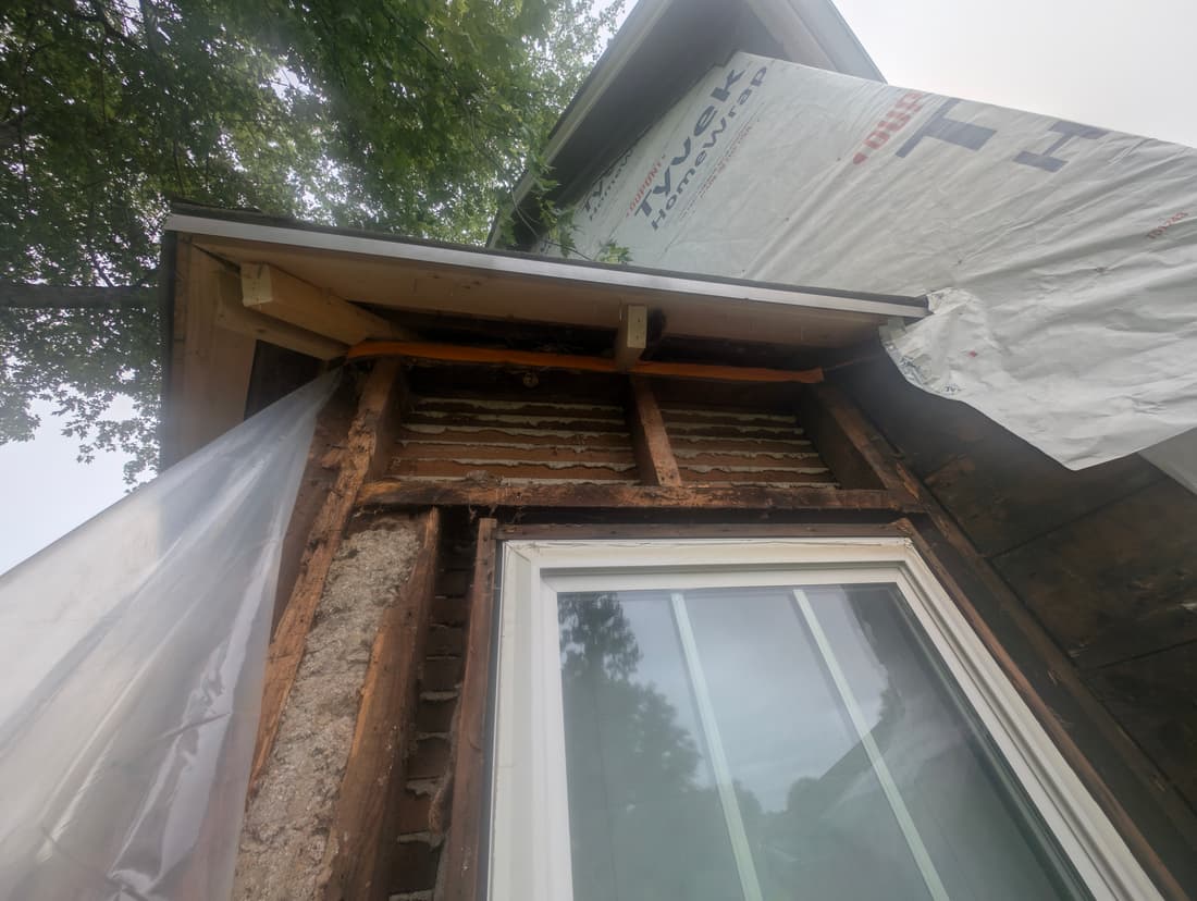 The bay opened up at the roof line, with the old framing exposed.