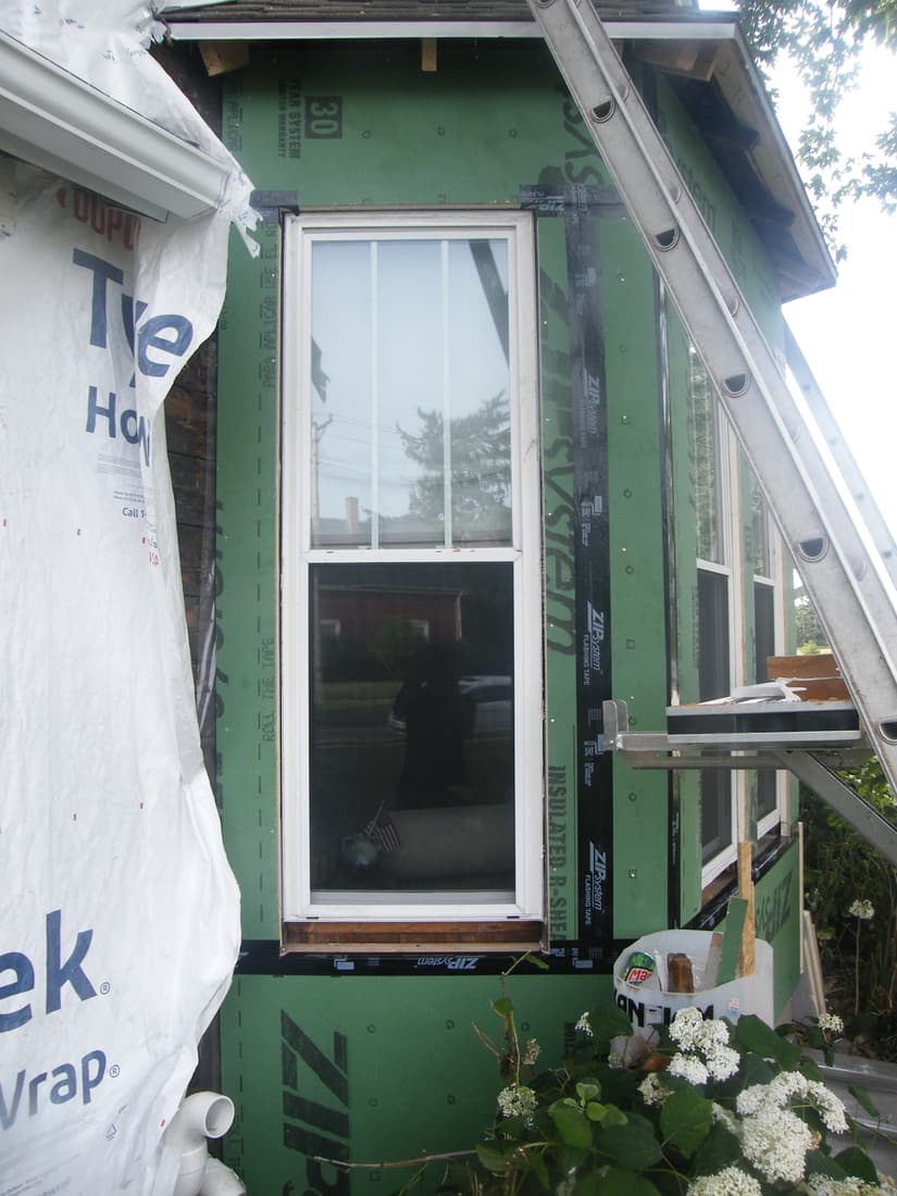 The bay resheathed in insulated panels, with the seams taped.