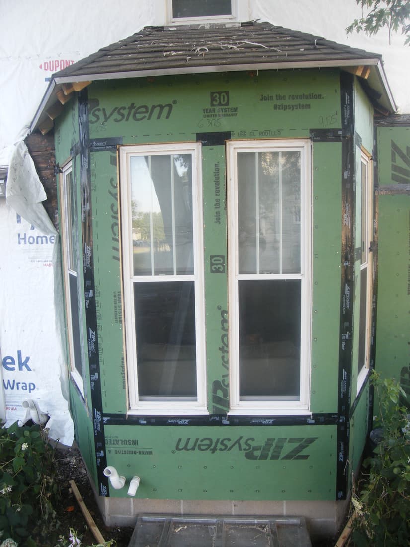The bay closed in and taped, windows back in.