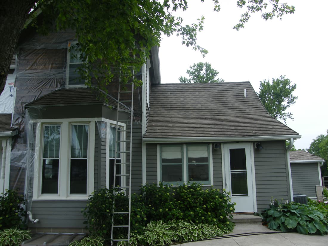 Sheeting hung over the upper east and north walls during tear-off.