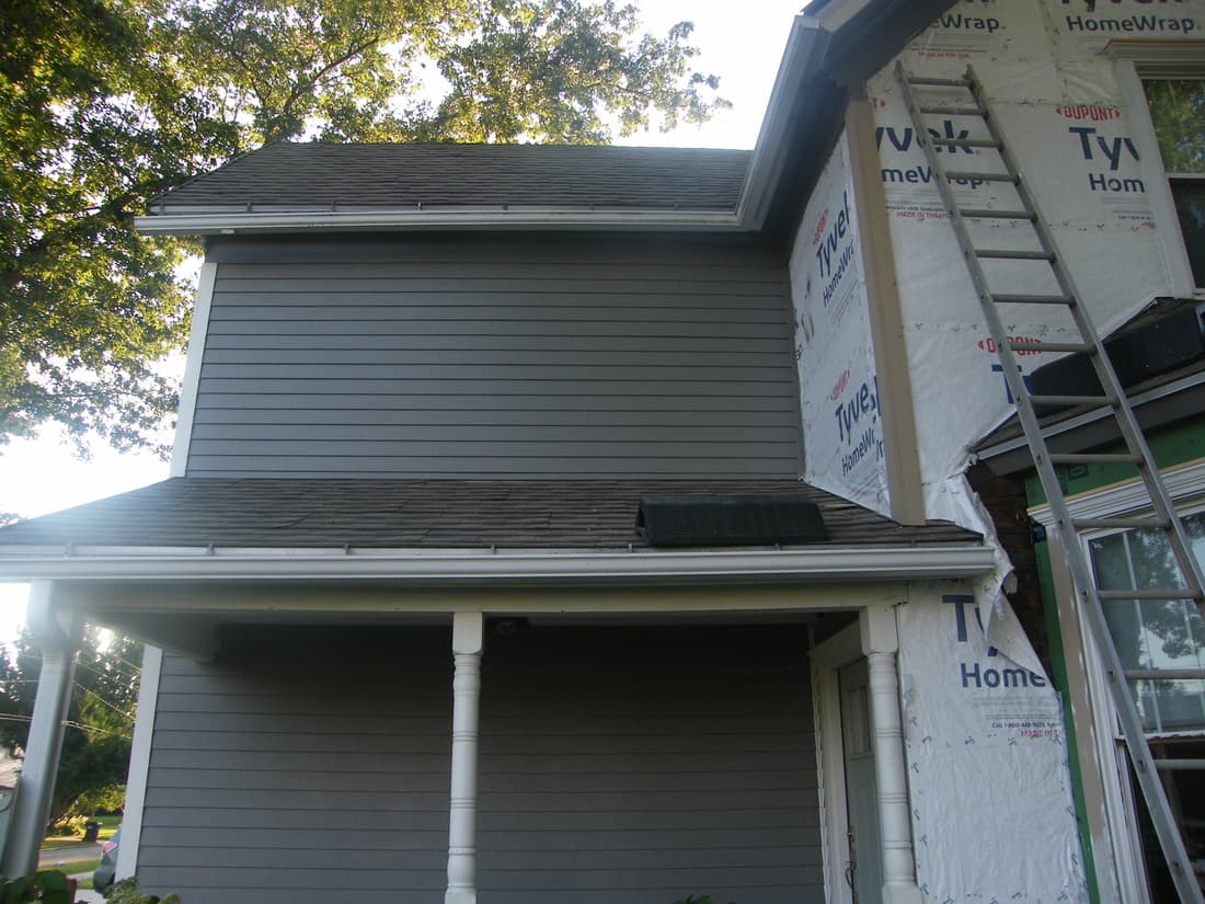 The wall above the porch sided, with the bay section still to go.