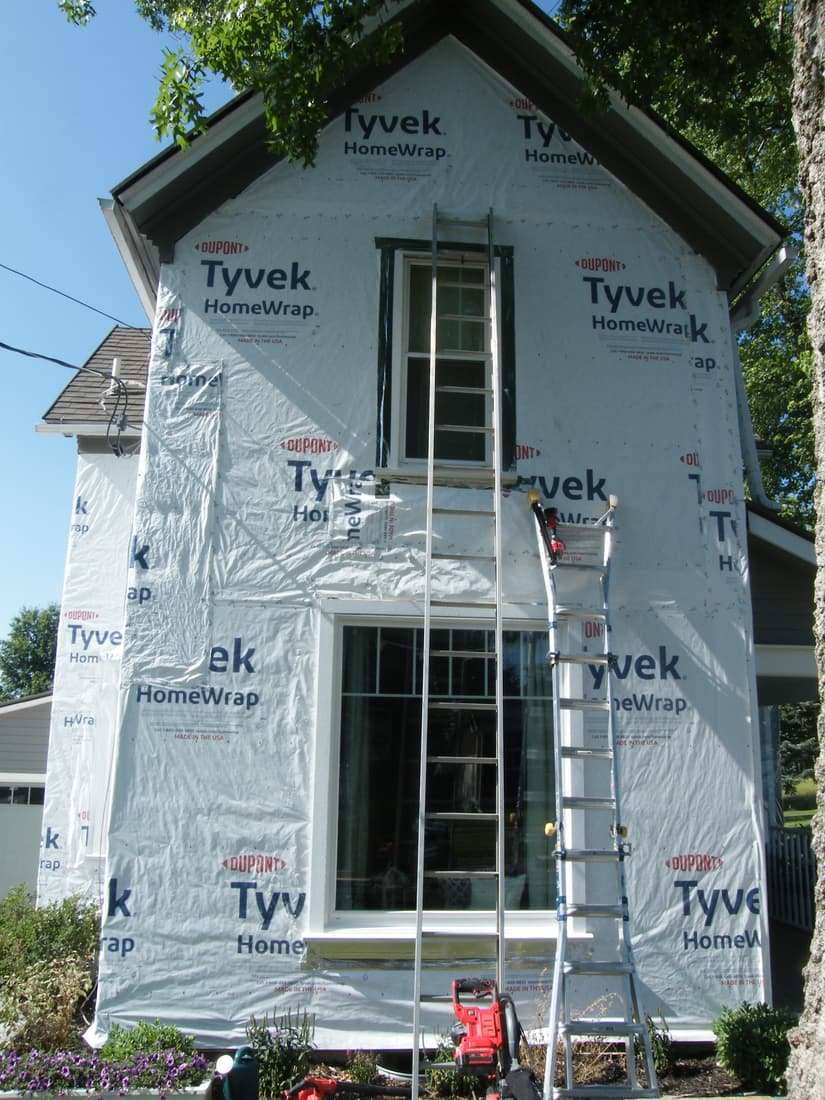 The south wall wrapped, with ladders set to take out the upper front sill.