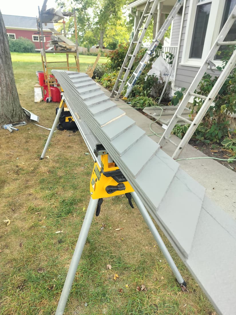 Siding for the gable above the bay, every piece cut to its own angle.