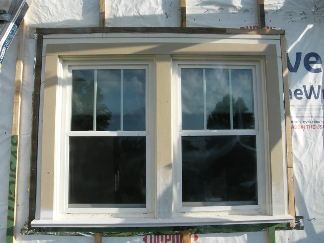 The north twin window cased out, with its new sill under.