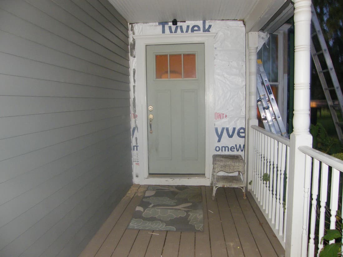 New siding on the porch wall, with the door still to be cased.