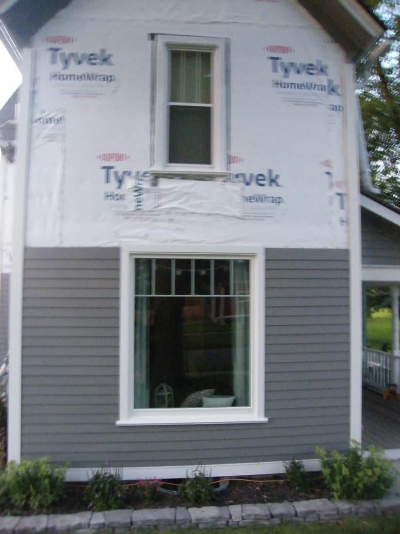 The south wall sided to the first floor line, the gable still wrapped.