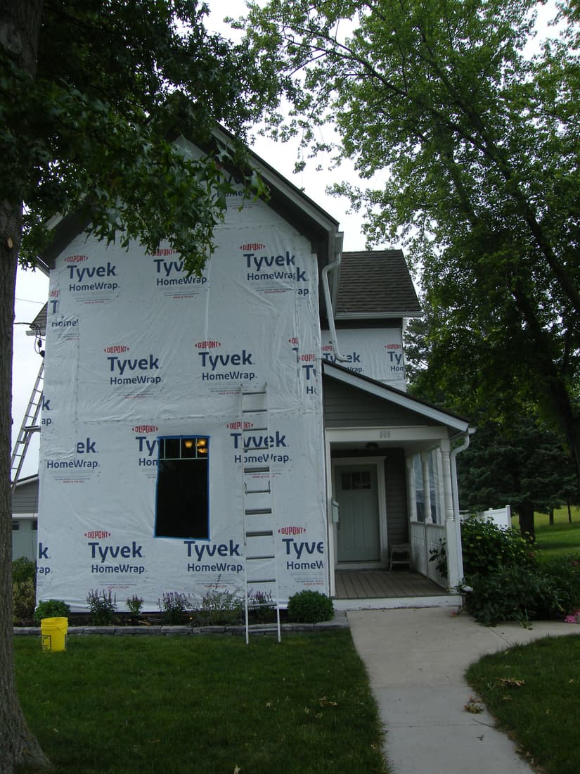 The south wall wrapped, ahead of trim and siding.
