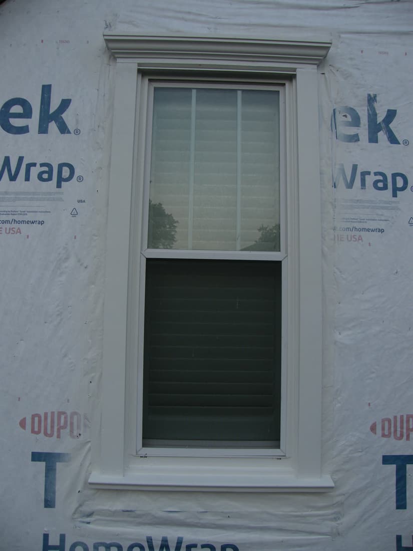 The first window finished: sill, side casing and head cornice all in place.