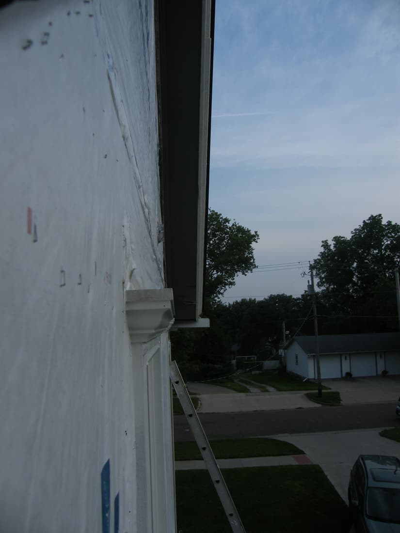 A new head cornice set over a window, seen from the ladder.