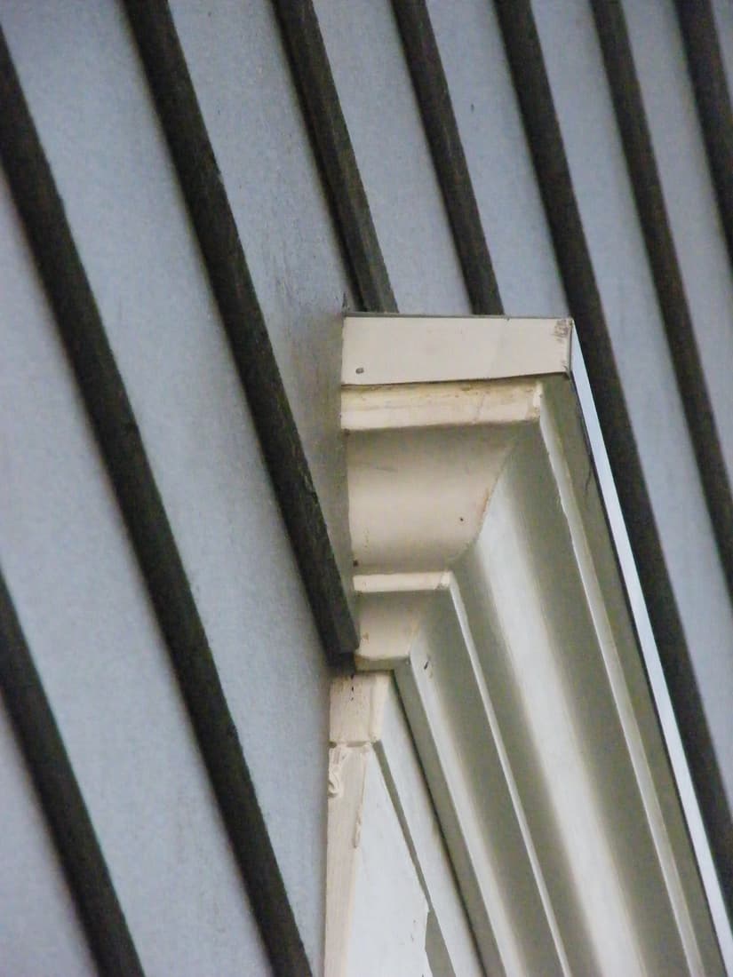 The head cornice detail against the new siding.